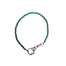 Green beaded bracelet with a clasp on a white background