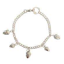 Silver bracelet with acorn charms on a white background