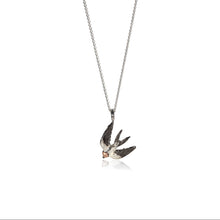 Necklace with a swallow pendant on a white background