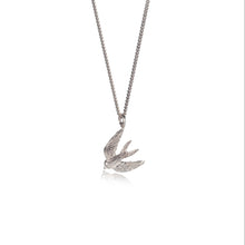 Silver bird-shaped pendant on a chain against a white background